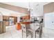 Open floor plan with a chandelier over a dining room table, stainless steel appliances and wood cabinets in the kitchen at 2620 Sw 152Nd Ln, Ocala, FL 34473