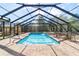 Backyard pool and patio featuring a screened-in enclosure, hot tub, and outdoor seating at 2620 Sw 152Nd Ln, Ocala, FL 34473