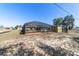 View of the screened in pool area in the backyard with an outbuilding and partial fencing at 2620 Sw 152Nd Ln, Ocala, FL 34473