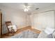 Bedroom with hardwood floors, ceiling fan, and closet, offering a comfortable retreat at 3001 Rugby Way, The Villages, FL 32162