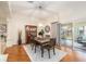 Well-lit dining room with wooden table, chairs, and a cabinet complemented by a light fixture at 3001 Rugby Way, The Villages, FL 32162