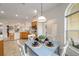 View of dining area connecting to kitchen with pendant lighting and a blue table at 3001 Rugby Way, The Villages, FL 32162