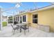 The screened patio includes a table and chairs, offering a relaxing outdoor space connected to the home at 3001 Rugby Way, The Villages, FL 32162