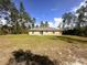 Rear exterior of the home and backyard with mature trees at 3044 Sw 168Th Loop, Ocala, FL 34473