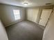 Cozy bedroom features neutral carpet, a double door closet, and natural light from a window at 3044 Sw 168Th Loop, Ocala, FL 34473