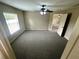 Spacious carpeted bedroom with natural light, ceiling fan, and a neutral color scheme at 3044 Sw 168Th Loop, Ocala, FL 34473