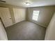 Cozy bedroom featuring a neutral carpet, a window with blinds, and a closet for ample storage at 3044 Sw 168Th Loop, Ocala, FL 34473