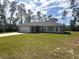 Charming single-story home with a well-manicured lawn, a long driveway, and an attached two-car garage at 3044 Sw 168Th Loop, Ocala, FL 34473