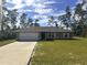 Charming single-story home with a well-manicured lawn, a long driveway, and an attached two-car garage at 3044 Sw 168Th Loop, Ocala, FL 34473