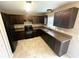 Well-lit kitchen with dark cabinets, modern appliances, and tiled floors at 3044 Sw 168Th Loop, Ocala, FL 34473