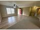 Inviting living room featuring hardwood floors, a ceiling fan, and a bright red front door at 3044 Sw 168Th Loop, Ocala, FL 34473