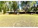 Spacious backyard featuring mature trees, a playground, a picnic table, and privacy fence at 3175 Ne 32Nd Ave, Ocala, FL 34479