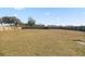 Large grassy backyard enclosed by a wood fence under a bright blue sky at 3994 Sw 102Nd Pl, Ocala, FL 34476