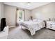 Cozy bedroom featuring neutral walls, carpet, and a window with sheer curtains at 3994 Sw 102Nd Pl, Ocala, FL 34476