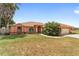 Inviting front exterior of a charming home with lush landscaping, and a two-car garage at 3994 Sw 102Nd Pl, Ocala, FL 34476