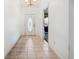 The foyer features neutral tile floors and chandelier lighting at 3994 Sw 102Nd Pl, Ocala, FL 34476