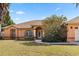 Lovely one story home with arched windows, manicured lawn, and a mature bush at 3994 Sw 102Nd Pl, Ocala, FL 34476