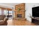 Living room shows a fireplace with stone surround and sliding doors to the outside at 3994 Sw 102Nd Pl, Ocala, FL 34476