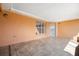 Enclosed porch with peach colored walls and tiled flooring with a window and glass door at 3994 Sw 102Nd Pl, Ocala, FL 34476