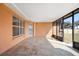 Enclosed porch with peach colored walls and tiled flooring with a view of the backyard at 3994 Sw 102Nd Pl, Ocala, FL 34476