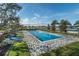 Sparkling swimming pool with surrounding brick-patterned deck and manicured landscaping at 4050 Nw 44Th Cir, Ocala, FL 34482