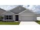 Charming single-story home showcasing a well-manicured lawn and attached two-car garage at 4739 Sw 88Th Ln, Ocala, FL 34476