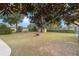 Spacious backyard features mature trees, a fire pit, and a storage shed, ideal for outdoor activities at 4837 Ne 5Th Street Rd, Ocala, FL 34470