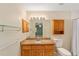 Bathroom featuring a granite vanity with wooden cabinets and a large mirror at 4837 Ne 5Th Street Rd, Ocala, FL 34470