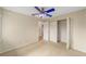 A carpeted bedroom with neutral walls and a fan at 4837 Ne 5Th Street Rd, Ocala, FL 34470