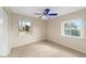 Cozy carpeted bedroom filled with natural light from two bright windows at 4837 Ne 5Th Street Rd, Ocala, FL 34470