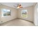 Bedroom with carpet, fan, and ample natural light from two windows at 4837 Ne 5Th Street Rd, Ocala, FL 34470