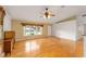 Bright living room featuring hardwood floors, a ceiling fan, and natural light at 4837 Ne 5Th Street Rd, Ocala, FL 34470