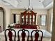 Spacious dining room featuring chandelier, table with leaf and 6 chairs, and an elegant china cabinet at 5765 Sw 164Th Pl, Ocala, FL 34473