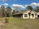 Well-manicured lawn surrounds this charming home, creating a welcoming curb appeal at 5765 Sw 164Th Pl, Ocala, FL 34473