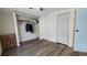 This bedroom features a spacious closet, wood-look flooring, and a closet space ready for organization at 615 Ne Cottage Park Ln, Leesburg, FL 34748