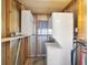 Laundry room featuring a washer and dryer, shelving, and exposed framework at 615 Ne Cottage Park Ln, Leesburg, FL 34748