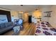 Cozy living room that leads to the kitchen with wood-look floors at 615 Ne Cottage Park Ln, Leesburg, FL 34748