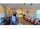 Cozy living room that leads to the kitchen with wood-look floors at 615 Ne Cottage Park Ln, Leesburg, FL 34748