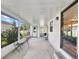 Enclosed patio with door to back and sliding doors to interior of the house at 615 Ne Cottage Park Ln, Leesburg, FL 34748
