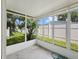 Enclosed patio featuring white walls, a concrete floor, and a view to the yard at 615 Ne Cottage Park Ln, Leesburg, FL 34748