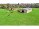 Aerial view of multiple horses grazing on a fenced-in pasture containing two buildings on a sunny day at 6994 Nw 320 Hwy, Micanopy, FL 32667