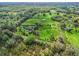 High altitude aerial view of large land parcel including green pastures, wooded areas and other improvements at 6994 Nw 320 Hwy, Micanopy, FL 32667