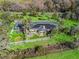 Aerial view of a home, white fence, lush landscaping, and ample green space at 6994 Nw 320 Hwy, Micanopy, FL 32667