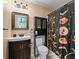 Cozy bathroom featuring a vanity, toilet, and tub with a decorative shower curtain at 6994 Nw 320 Hwy, Micanopy, FL 32667