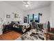 Bedroom with a decorative floral rug, dark wood furniture, and a window-adjacent desk at 6994 Nw 320 Hwy, Micanopy, FL 32667