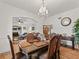 Formal dining room featuring hardwood floors, ornate chandelier, and seamless flow into the living area at 6994 Nw 320 Hwy, Micanopy, FL 32667