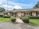 Charming home with a manicured lawn, mature landscaping, and classic architecture at 6994 Nw 320 Hwy, Micanopy, FL 32667