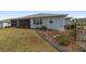 Rear exterior view of screened lanai and landscaped backyard at 8107 Sw 92Nd Cir, Ocala, FL 34481