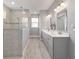 Elegant bathroom with a glass enclosed shower, double vanity, and modern fixtures, offering a spa-like experience at 8107 Sw 92Nd Cir, Ocala, FL 34481