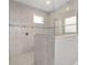 Tiled walk-in shower with glass surround and bench at 8107 Sw 92Nd Cir, Ocala, FL 34481